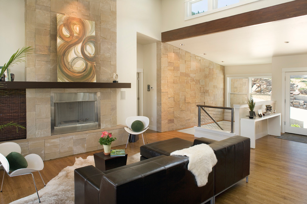 Photo of a contemporary family room in Boise with a stone fireplace surround.