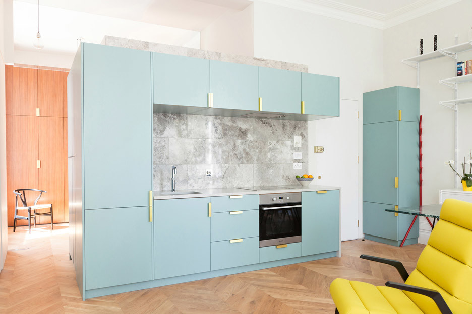 Mid-sized contemporary single-wall open plan kitchen in London with an undermount sink, flat-panel cabinets, stone tile splashback and no island.