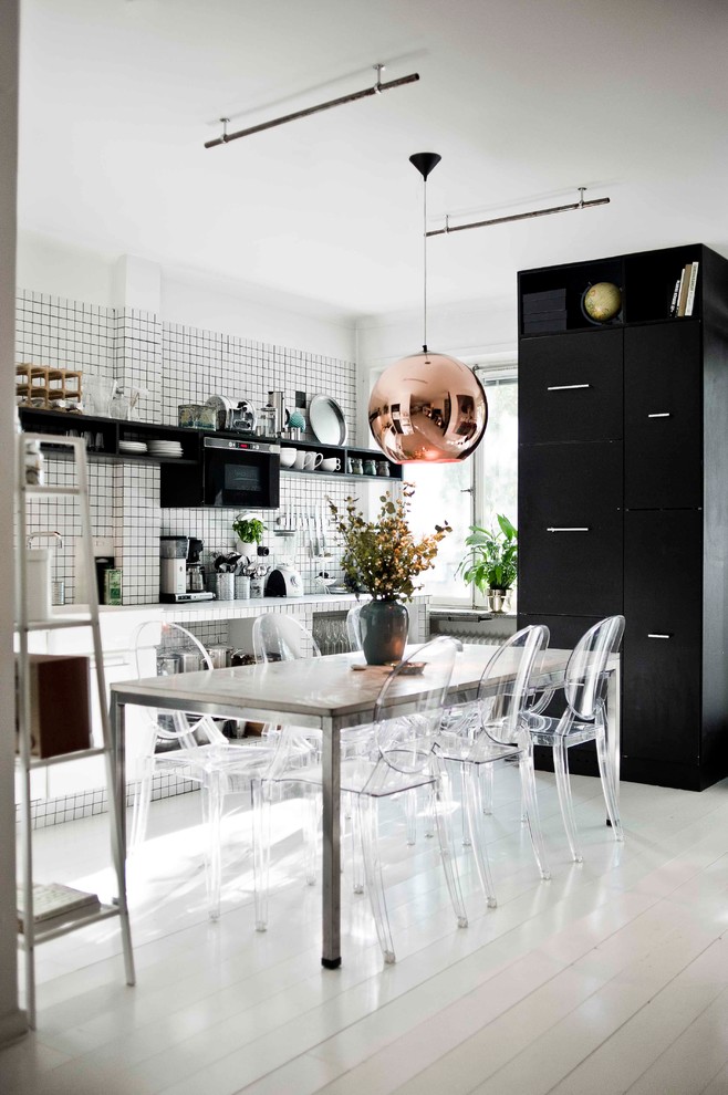 Inspiration for a mid-sized scandinavian kitchen/dining combo in Gothenburg with white walls, painted wood floors and no fireplace.