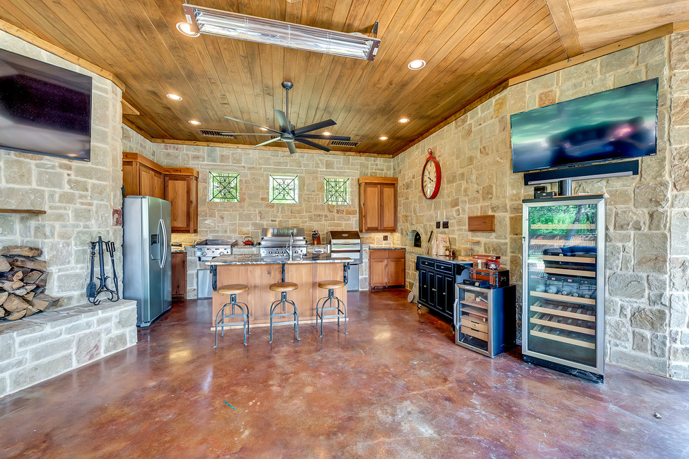 This is an example of a country kitchen in Dallas with stainless steel appliances and with island.