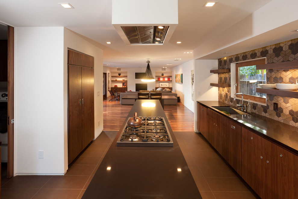 Design ideas for a mid-sized modern galley kitchen in Sacramento with an undermount sink, flat-panel cabinets, dark wood cabinets, multi-coloured splashback, solid surface benchtops, ceramic splashback, stainless steel appliances, ceramic floors and with island.