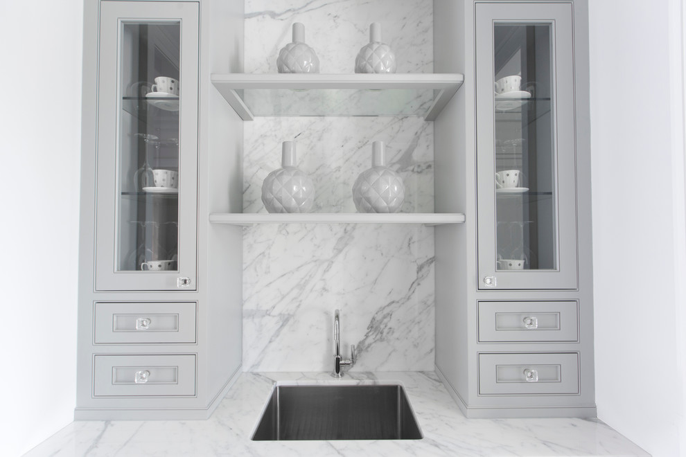Inspiration for a large contemporary single-wall wet bar in Toronto with an undermount sink, beaded inset cabinets, marble benchtops, grey splashback, grey cabinets and marble splashback.