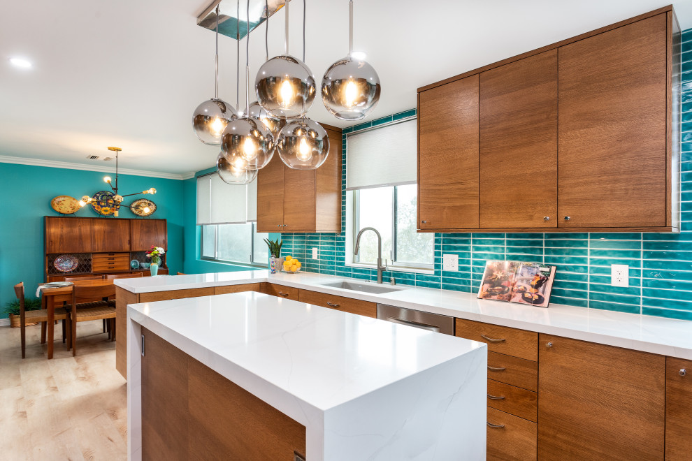 Design ideas for a small midcentury galley eat-in kitchen in Los Angeles with an undermount sink, flat-panel cabinets, medium wood cabinets, quartz benchtops, blue splashback, stainless steel appliances, laminate floors, with island and white benchtop.