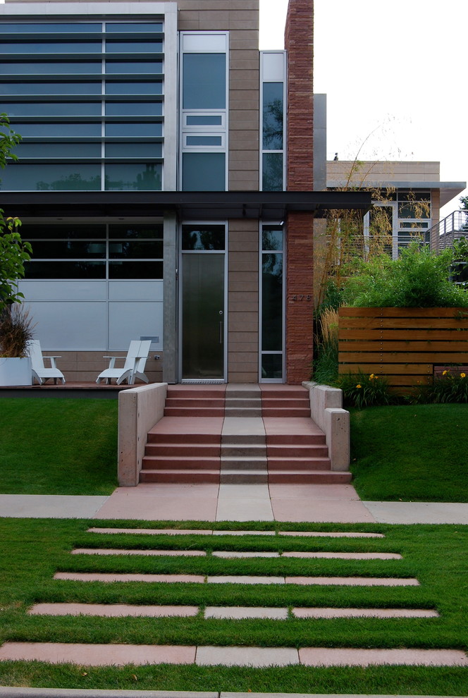 Large contemporary backyard formal garden in Denver with a garden path and natural stone pavers.