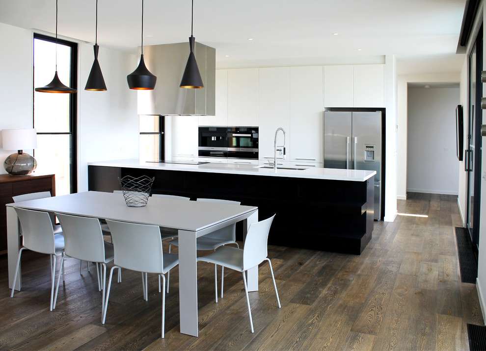 Design ideas for a mid-sized contemporary l-shaped eat-in kitchen in Melbourne with an undermount sink, flat-panel cabinets, stainless steel appliances, dark hardwood floors and with island.