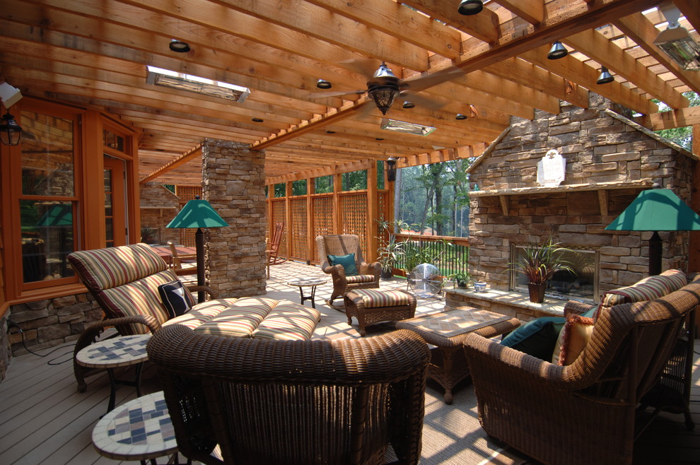 This is an example of an expansive country backyard deck in Atlanta with an outdoor kitchen and a pergola.