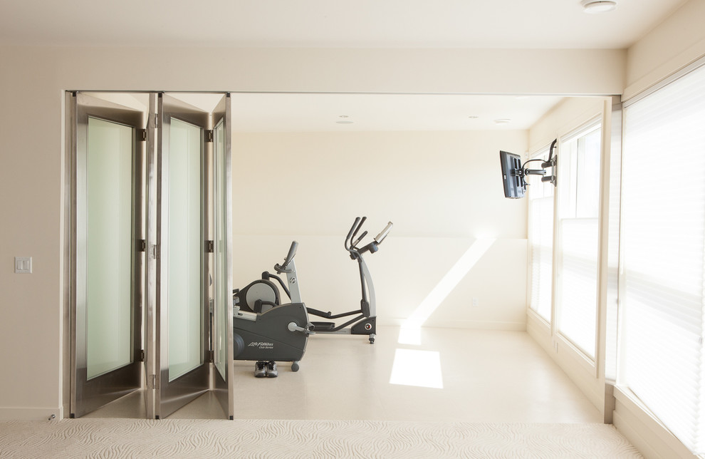 Contemporary home gym in Edmonton with white walls and white floor.