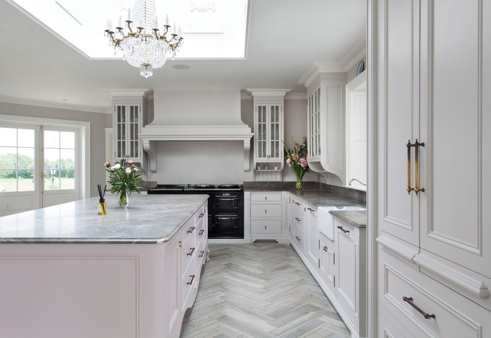 Inspiration for a large l-shaped eat-in kitchen in Other with recessed-panel cabinets, white cabinets, with island, a farmhouse sink, grey floor and grey benchtop.