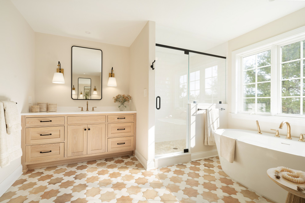 Inspiration for a transitional beige floor and single-sink freestanding bathtub remodel in Philadelphia with shaker cabinets, light wood cabinets, beige walls, an undermount sink, a hinged shower door, white countertops and a built-in vanity