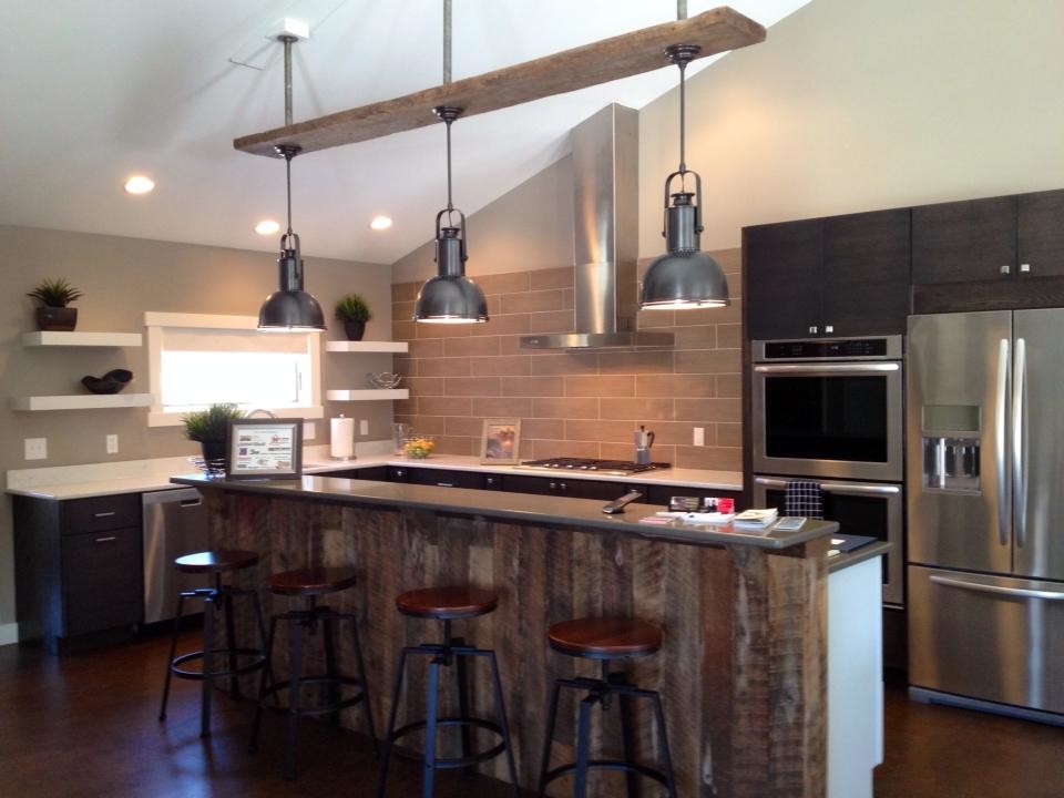 Example of a large mountain style l-shaped cork floor and brown floor enclosed kitchen design in New York with an undermount sink, flat-panel cabinets, medium tone wood cabinets, quartz countertops, gray backsplash, porcelain backsplash, stainless steel appliances and an island