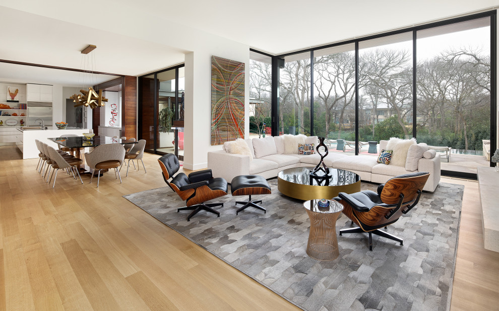 North Dallas - Inspiration for a mid-sized contemporary open concept light wood floor and beige floor living room remodel in Dallas with white walls, a ribbon fireplace, a stone fireplace and a wall-mounted tv
