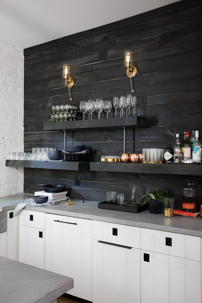 This is an example of a small modern u-shaped wet bar in Seattle with flat-panel cabinets, white cabinets, concrete benchtops, black splashback, timber splashback and grey benchtop.