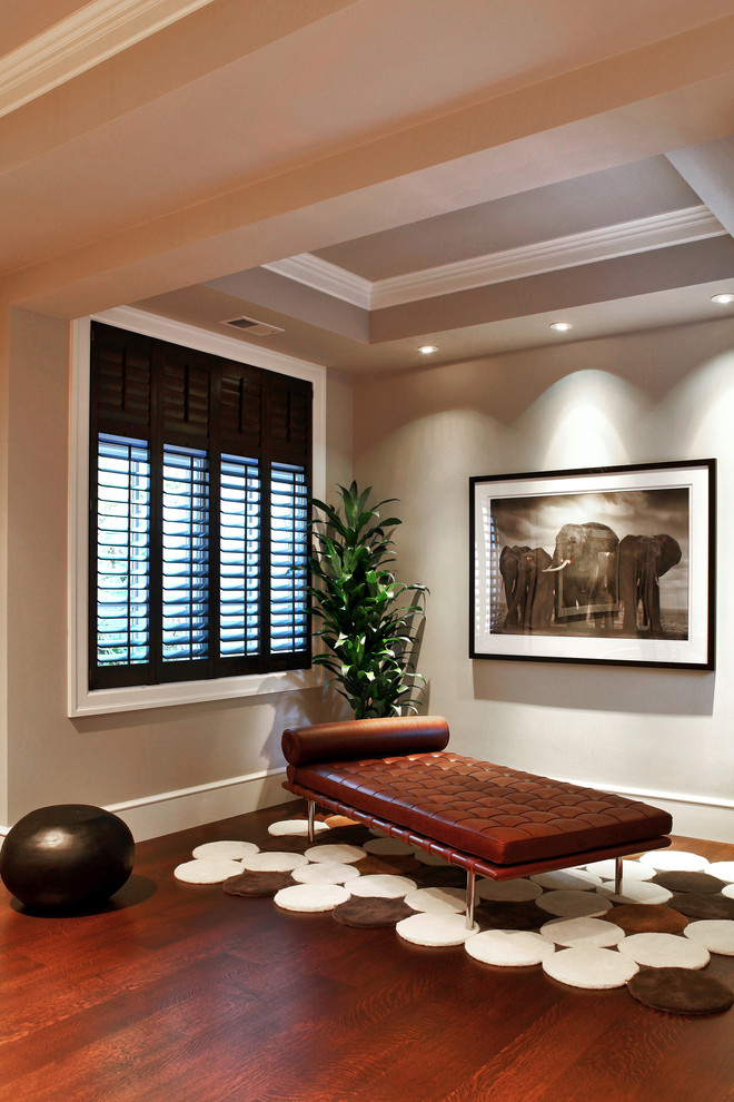 Photo of a contemporary family room in New York with beige walls and dark hardwood floors.