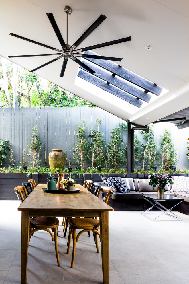 Photo of a contemporary backyard patio in Brisbane with concrete pavers.