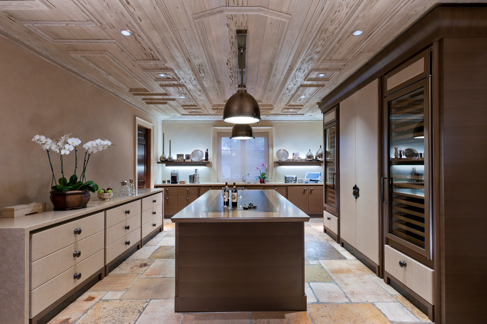 Inspiration for a large traditional separate kitchen in Miami with flat-panel cabinets, medium wood cabinets, panelled appliances, limestone floors, with island and quartz benchtops.