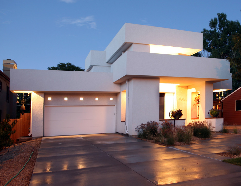 This is an example of a contemporary two-storey exterior in Denver with a flat roof.