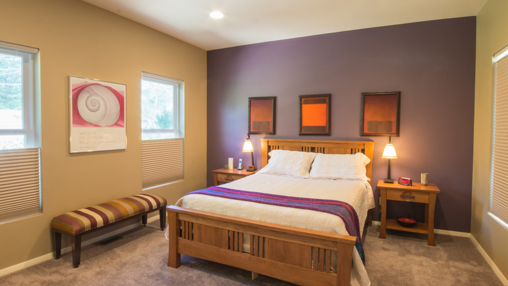 This is an example of a large traditional master bedroom in Denver with purple walls and carpet.