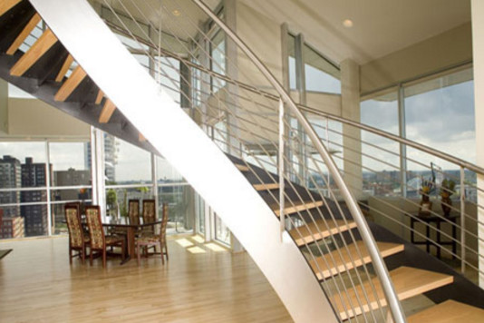 Inspiration for a mid-sized contemporary wooden curved staircase remodel in Cleveland with metal risers