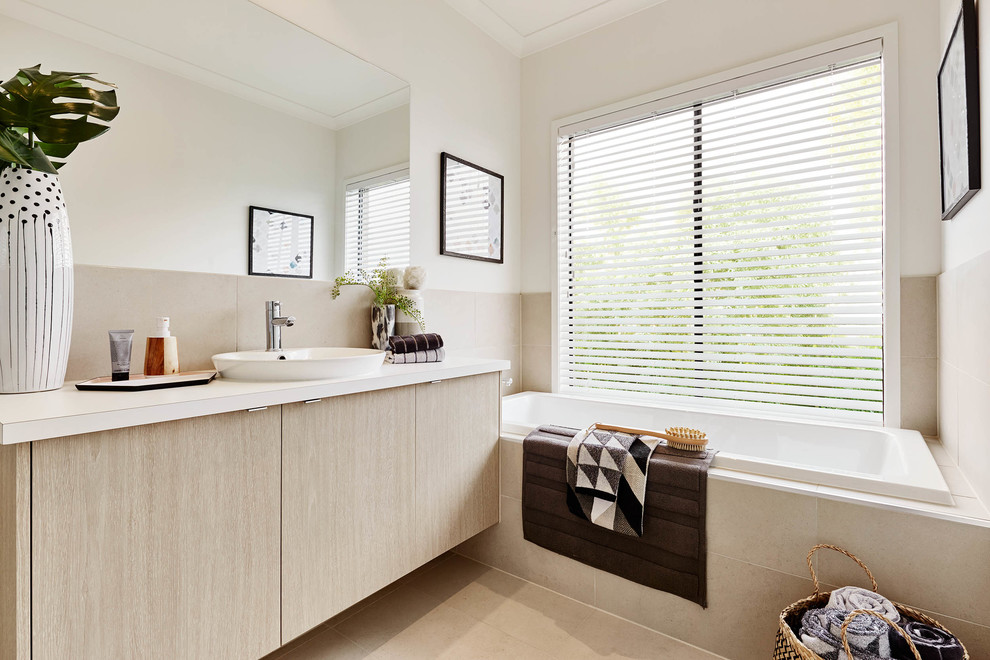 Photo of a contemporary bathroom in Melbourne with flat-panel cabinets, beige cabinets, a drop-in tub, white walls and a drop-in sink.