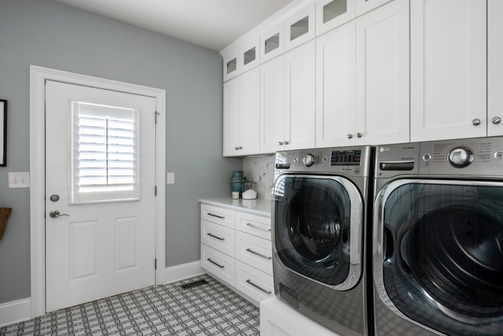 Design ideas for a small transitional galley dedicated laundry room in Charlotte with shaker cabinets, white cabinets, quartz benchtops, white splashback, marble splashback, blue walls, porcelain floors, a side-by-side washer and dryer, blue floor and white benchtop.