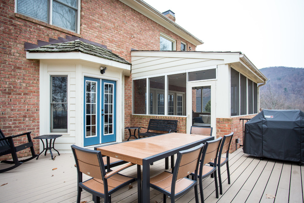 Example of a mid-sized transitional backyard deck design with no cover
