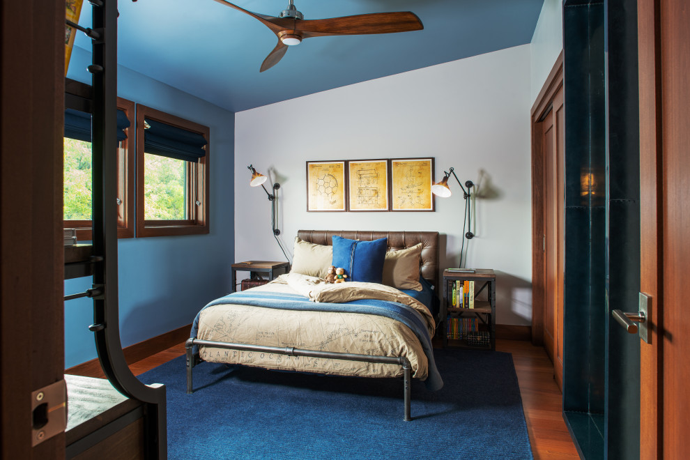 Design ideas for a mid-sized country bedroom in Omaha with blue walls, dark hardwood floors and red floor.