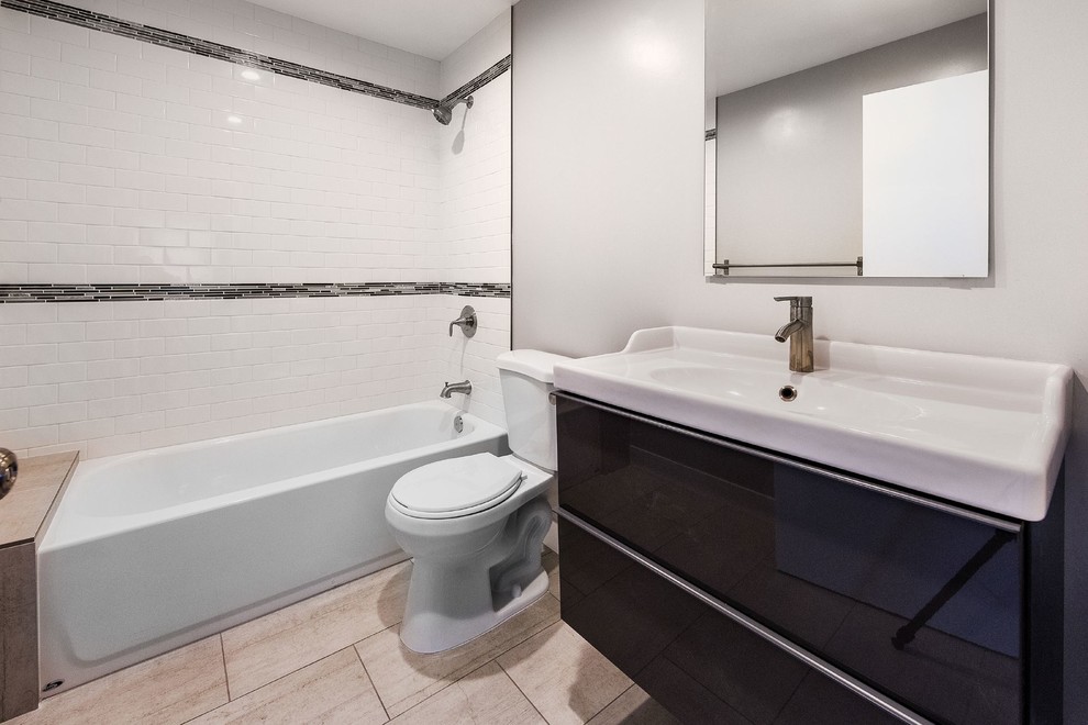 Design ideas for a mid-sized contemporary master bathroom in Los Angeles with grey cabinets, a shower/bathtub combo, white tile, ceramic tile, grey walls and porcelain floors.