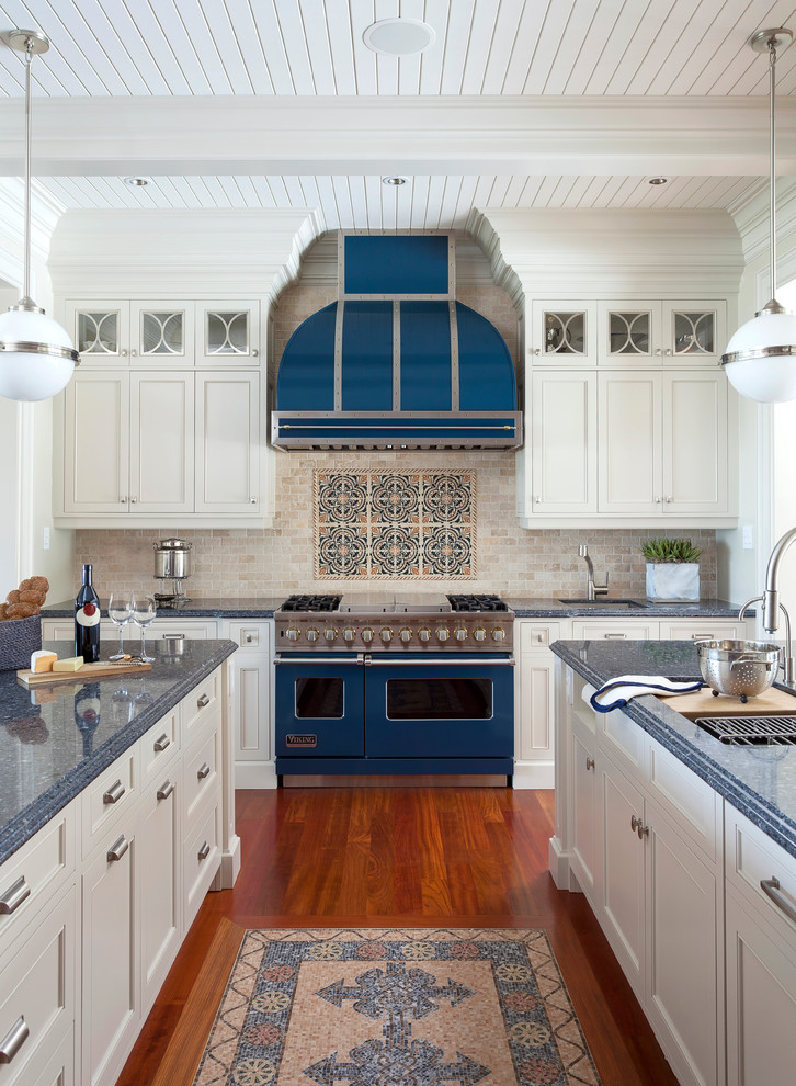 Inspiration for a traditional kitchen in Toronto with an undermount sink, recessed-panel cabinets, white cabinets, beige splashback, coloured appliances, dark hardwood floors, multiple islands and blue benchtop.
