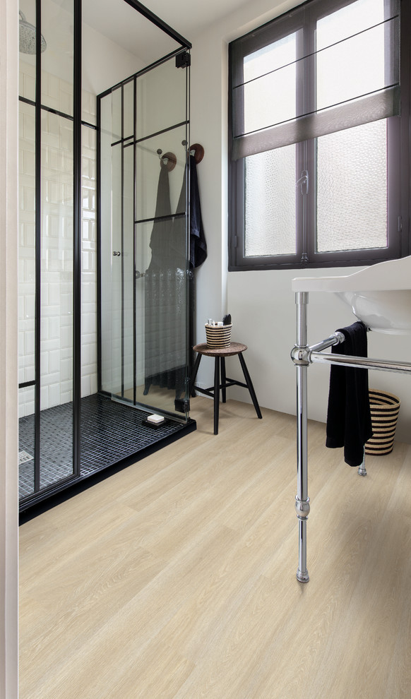 Inspiration for a small modern 3/4 bathroom with beige floor, a corner shower, white walls, laminate floors and a hinged shower door.