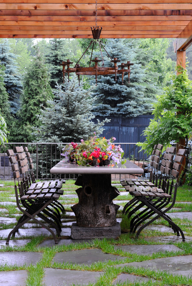 Inspiration for a mid-sized country backyard patio in New York with natural stone pavers and a pergola.