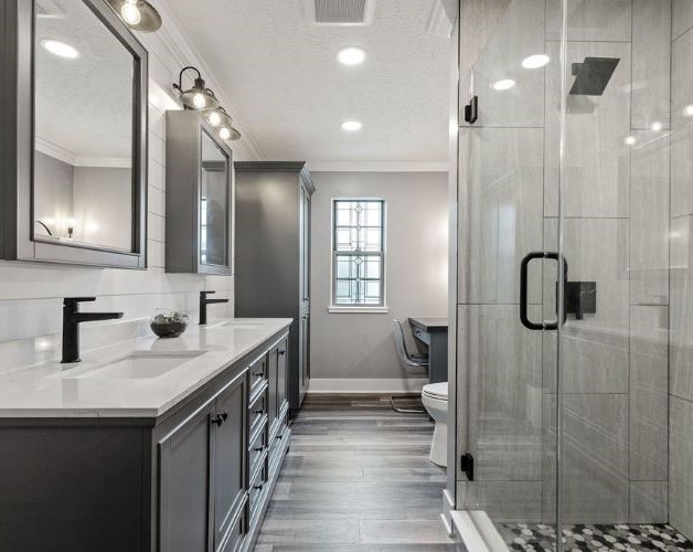 This is an example of a transitional 3/4 bathroom in Columbus with recessed-panel cabinets, grey cabinets, an alcove shower, gray tile, an undermount sink, quartzite benchtops, grey floor, a hinged shower door, turquoise benchtops, a double vanity, a built-in vanity and planked wall panelling.