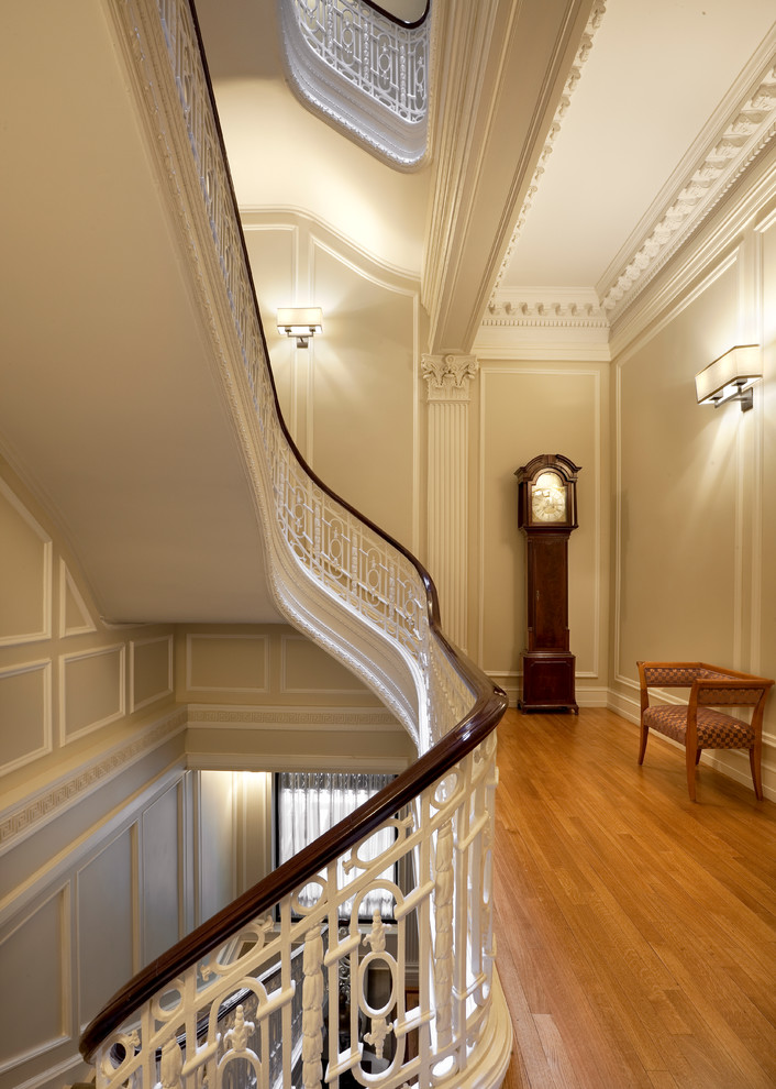 Design ideas for a mid-sized traditional hallway in New York with beige walls and light hardwood floors.