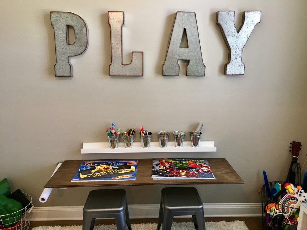 Photo of a mid-sized traditional kids' playroom for kids 4-10 years old and boys in Jacksonville with grey walls and medium hardwood floors.
