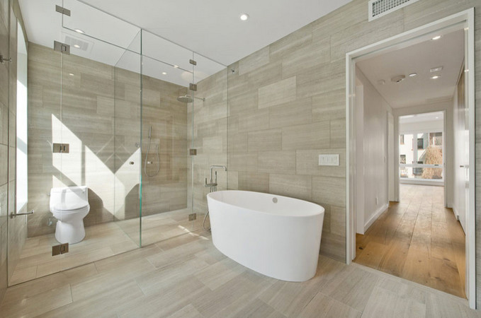 Inspiration for a contemporary master bathroom in New York with a claw-foot tub and an open shower.