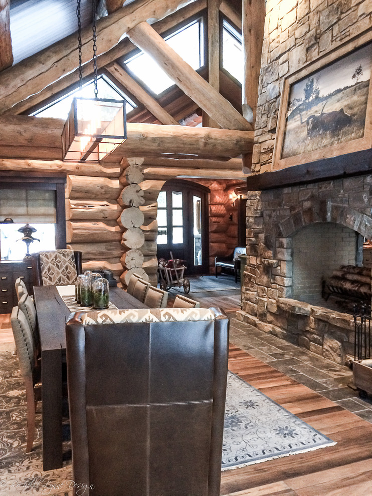 Large mountain style medium tone wood floor great room photo in Calgary with a two-sided fireplace and a stone fireplace