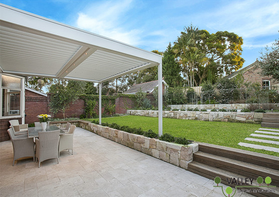 Large modern backyard patio in Sydney with concrete pavers.