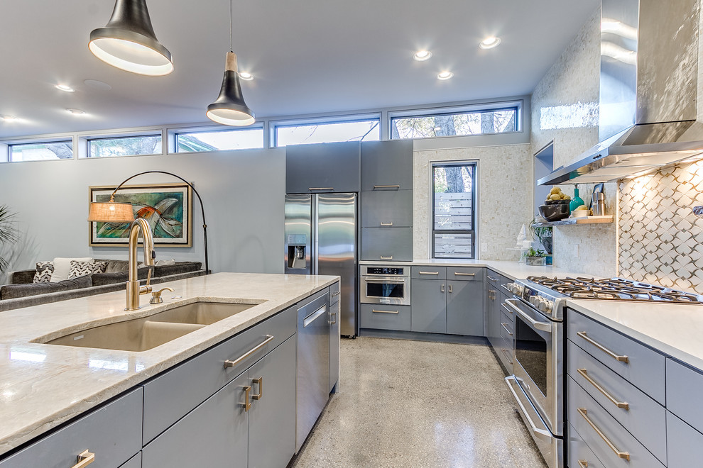 Mid-sized contemporary l-shaped open plan kitchen in Oklahoma City with a double-bowl sink, flat-panel cabinets, grey cabinets, quartzite benchtops, multi-coloured splashback, ceramic splashback, stainless steel appliances, concrete floors, with island and grey floor.