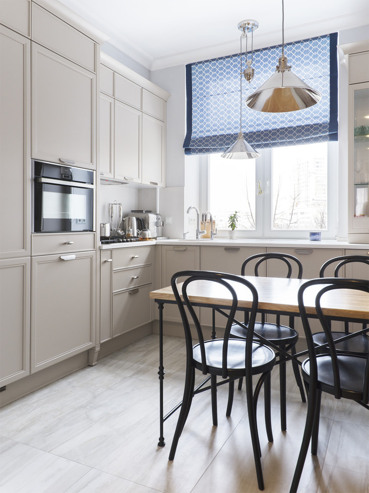 Traditional l-shaped separate kitchen in Moscow with a drop-in sink, recessed-panel cabinets, grey cabinets, white splashback, window splashback, black appliances and no island.
