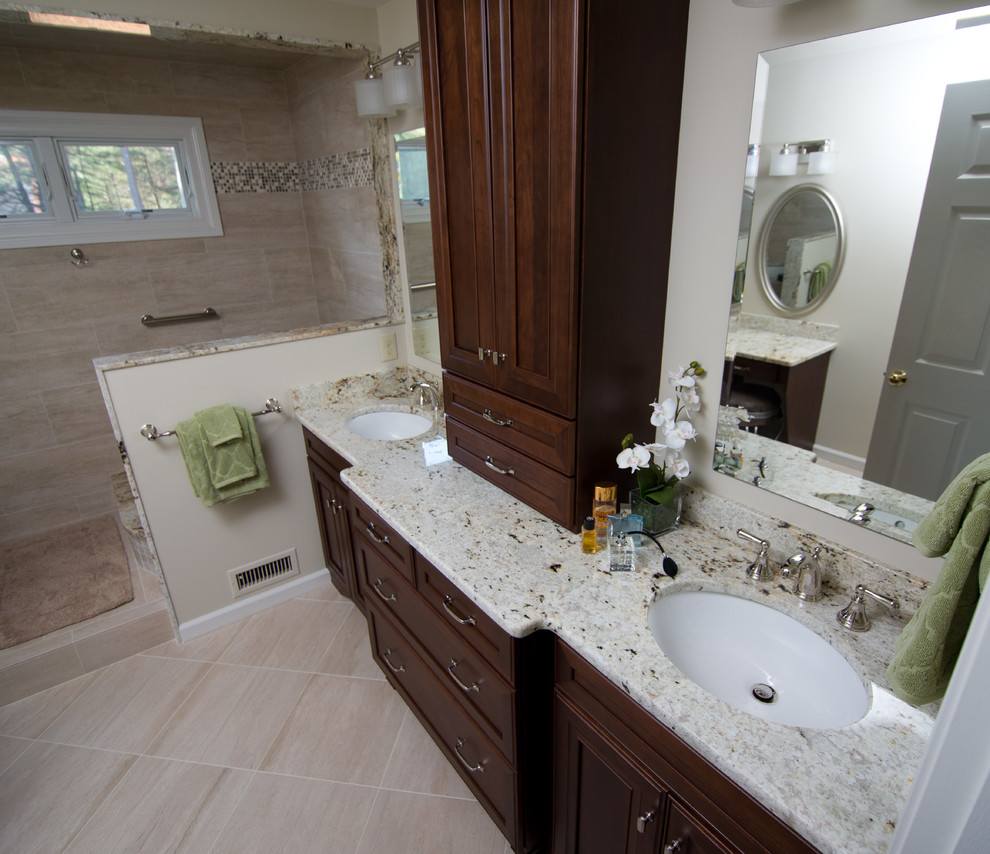 This is an example of a traditional master wet room bathroom in Boston with shaker cabinets, dark wood cabinets, a japanese tub, a two-piece toilet, beige tile, porcelain tile, beige walls, porcelain floors, an undermount sink, granite benchtops, beige floor, an open shower and beige benchtops.