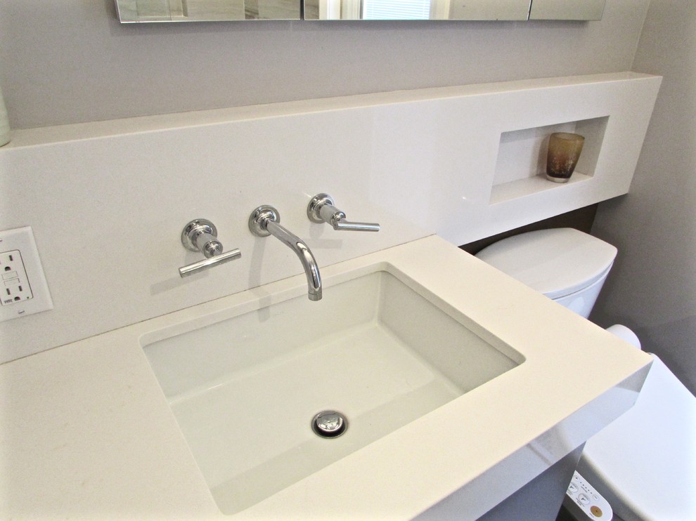 Inspiration for a small modern kids bathroom in San Francisco with an undermount sink, flat-panel cabinets, grey cabinets, engineered quartz benchtops, an alcove tub, a shower/bathtub combo, a bidet, beige tile, porcelain tile, beige walls and porcelain floors.