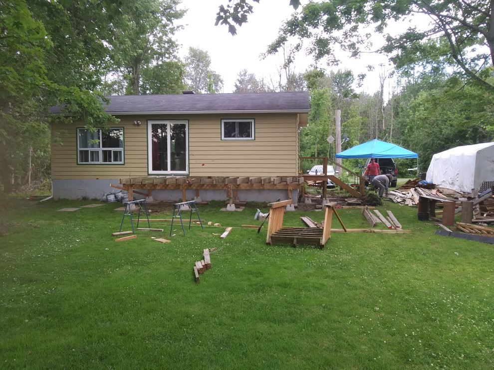 Deck - large transitional backyard wood railing deck idea in Ottawa