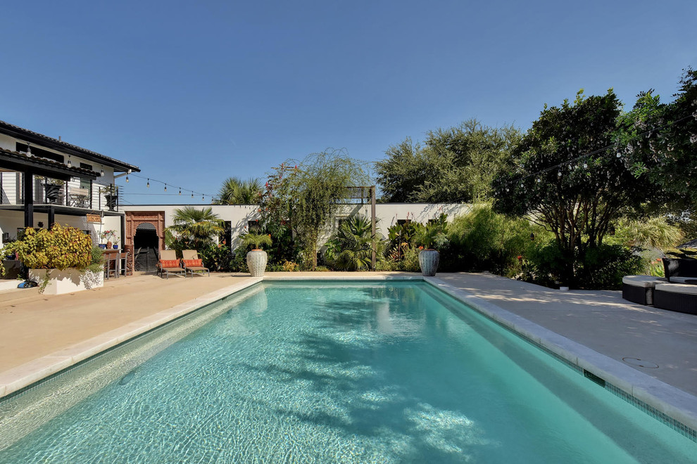 Pool house - mid-sized transitional backyard concrete and rectangular natural pool house idea in Austin