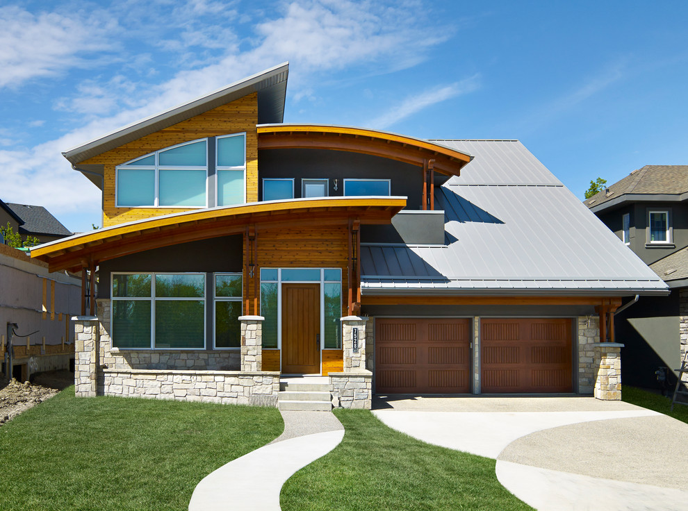 Photo of a contemporary exterior in Edmonton with wood siding.