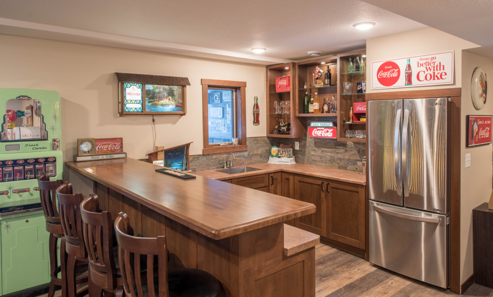 Inspiration for a small arts and crafts u-shaped home bar in Minneapolis with an undermount sink, shaker cabinets, medium wood cabinets, laminate benchtops, multi-coloured splashback, stone tile splashback, linoleum floors, brown floor and brown benchtop.