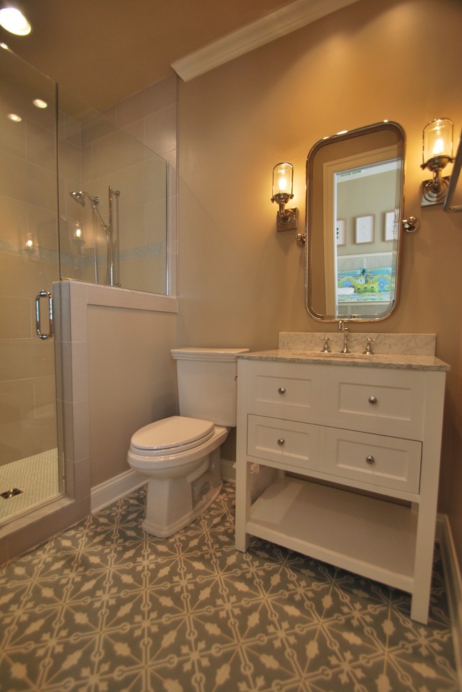 Inspiration for a small transitional 3/4 bathroom in DC Metro with beaded inset cabinets, white cabinets, an alcove shower, a two-piece toilet, beige tile, ceramic tile, beige walls, concrete floors, an undermount sink, marble benchtops, turquoise floor, a hinged shower door and grey benchtops.