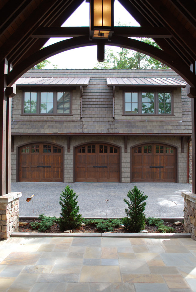 This is an example of a mid-sized traditional detached three-car porte cochere in Other.