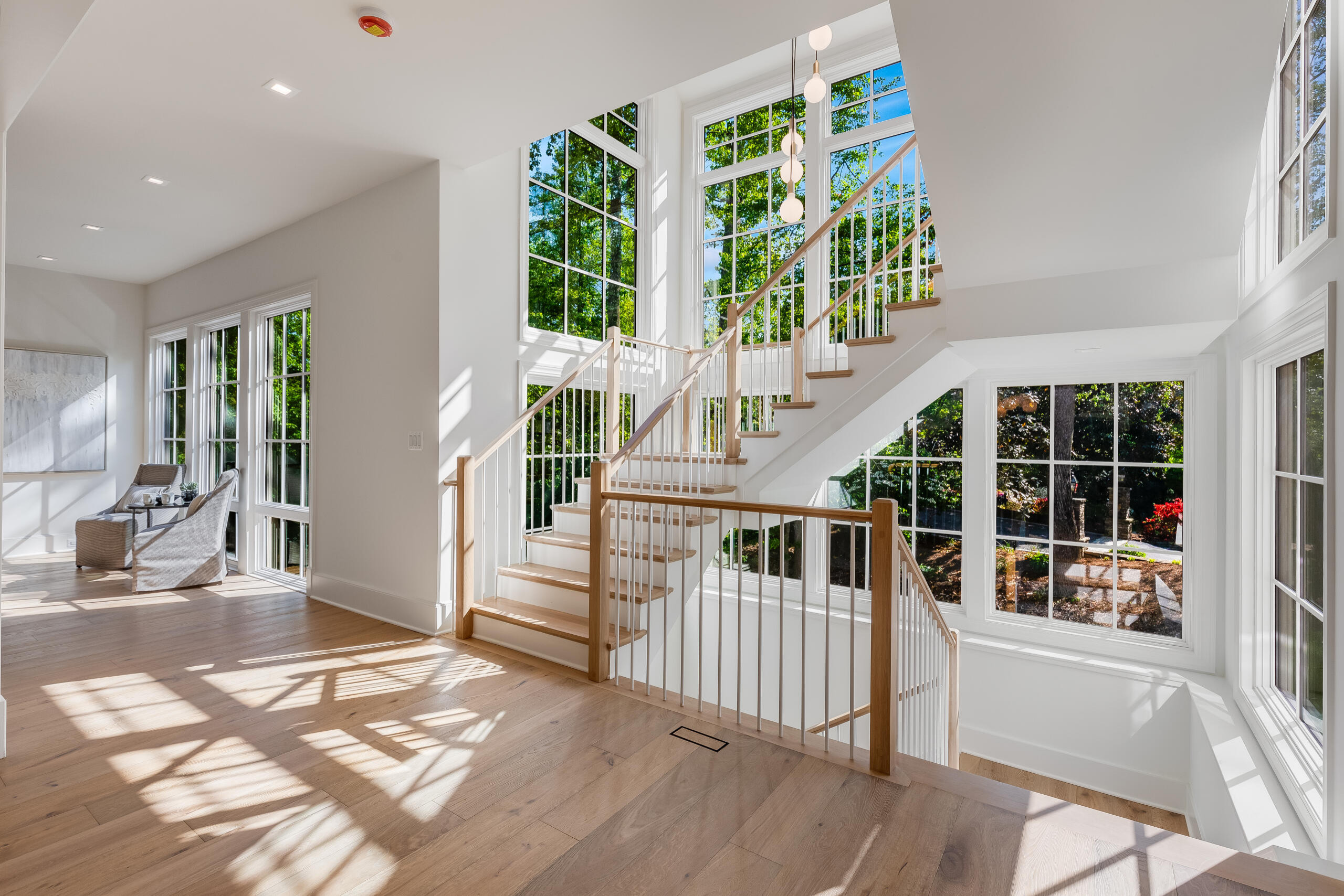 Project #152 | Three-Story White Oak Staircase with a Pendant Chandelier