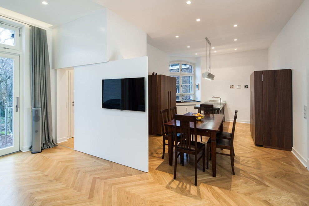 Inspiration for a mid-sized contemporary open plan dining in Dusseldorf with medium hardwood floors.