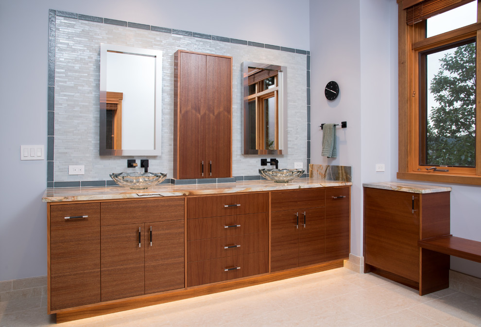 This is an example of a large contemporary master bathroom in Seattle with flat-panel cabinets, dark wood cabinets, a freestanding tub, a curbless shower, a bidet, beige tile, glass tile, purple walls, porcelain floors, a vessel sink, quartzite benchtops, beige floor, a hinged shower door, beige benchtops, a double vanity and a built-in vanity.