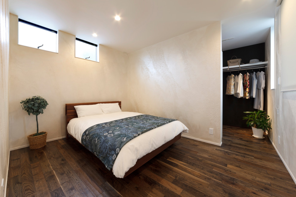Master bedroom in Other with beige walls, dark hardwood floors, brown floor, wallpaper and planked wall panelling.